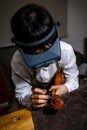 Young Chinese violin maker at work in her workshop Royalty Free Stock Photo