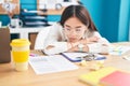 Young chinese woman business worker tired working at office