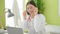 Young chinese woman doctor using laptop wearing glasses at clinic Royalty Free Stock Photo