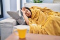 Young chinese woman ilness lying on sofa at home Royalty Free Stock Photo