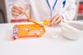 Young chinese woman pharmacist organizing pills dose at atelier