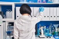 Young chinese woman scientist holding binder at laboratory Royalty Free Stock Photo