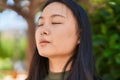 Young chinese woman scientist writing report reading book at park Royalty Free Stock Photo