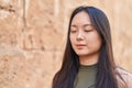 Young chinese woman scientist writing report reading book at street Royalty Free Stock Photo