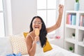 Young chinese woman singing song using brush as a microphone at bedroom Royalty Free Stock Photo