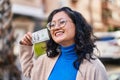 Young chinese woman smiling confident holding 100 dollars banknote at street Royalty Free Stock Photo