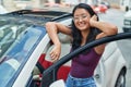 Young chinese woman smiling confident opening car door at street Royalty Free Stock Photo