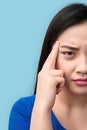 Freestyle. Chinese woman standing isolated on grey having headache wincing unhappy close-up Royalty Free Stock Photo