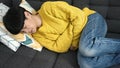 Young chinese woman suffering for stomach ache lying on sofa at home Royalty Free Stock Photo