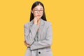 Young chinese woman wearing business clothes thinking looking tired and bored with depression problems with crossed arms Royalty Free Stock Photo