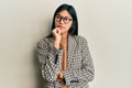 Young chinese woman wearing business style and glasses with hand on chin thinking about question, pensive expression Royalty Free Stock Photo