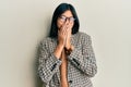 Young chinese woman wearing business style and glasses laughing and embarrassed giggle covering mouth with hands, gossip and Royalty Free Stock Photo