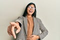 Young chinese woman wearing business style and glasses laughing at you, pointing finger to the camera with hand over body, shame Royalty Free Stock Photo