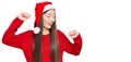 Young chinese woman wearing christmas hat dancing happy and cheerful, smiling moving casual and confident listening to music Royalty Free Stock Photo