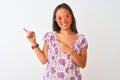 Young chinese woman wearing floral t-shirt and pink glasses over isolated white background smiling and looking at the camera Royalty Free Stock Photo