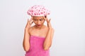 Young chinese woman wearing shower towel and cap bath over isolated white background with hand on head for pain in head because Royalty Free Stock Photo