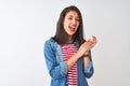 Young chinese woman wearing striped t-shirt and denim shirt over isolated white background clapping and applauding happy and Royalty Free Stock Photo