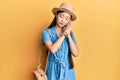 Young chinese woman wearing summer hat sleeping tired dreaming and posing with hands together while smiling with closed eyes Royalty Free Stock Photo