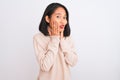 Young chinese woman wearing turtleneck sweater standing over isolated white background afraid and shocked, surprise and amazed Royalty Free Stock Photo