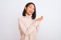 Young chinese woman wearing turtleneck sweater standing over isolated white background clapping and applauding happy and joyful, Royalty Free Stock Photo