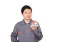 Young Chinese worker in overalls holding a small house model Royalty Free Stock Photo