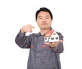 Young Chinese worker in overalls holding a small house model Royalty Free Stock Photo