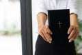 young christian girl holding bible in hand Read the Bible in the house. Concept for Faith, Royalty Free Stock Photo