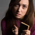 Young christian woman holding cross and psalm book Royalty Free Stock Photo