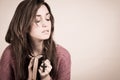 Young christian woman holding a cross and a psalm