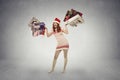 Young christmas girl smiling holding many shopping bags Royalty Free Stock Photo