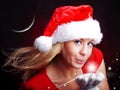 Young christmas woman holding star over dark Royalty Free Stock Photo