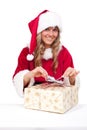 Young Christmas Woman is opening an xmas present Royalty Free Stock Photo