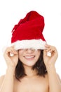 Young christmas woman using santa cap to cover eyes. Royalty Free Stock Photo