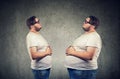 Young chubby man looking at fat himself feeling bloated. Royalty Free Stock Photo