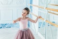 Beautiful graceful ballerina practice ballet positions in pink tutu skirt in dance class Royalty Free Stock Photo