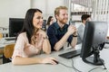 Young classmates looking at a monitor and studying