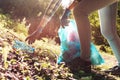 Young cleanup volunteer collecting trash in the forest