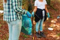 Cleanup volunteers collecting trash in the forest