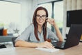 Young clever diligent woman toothy smile at laptop