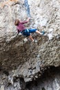 Young climber climbing the rock walls