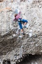 Young climber climbing the rock walls