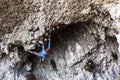 Young climber climbing the rock walls