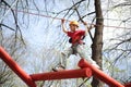 Young climber skilfully go on a suspension bridge Royalty Free Stock Photo