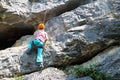 Young climbing girl on a rock wall