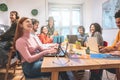 Young co-workers team talking during startup - Happy people planning a new project in creative coworking office - Technology,