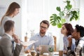 Young coach woman presenting report to colleagues in office Royalty Free Stock Photo