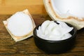 Young coconut meat sliced in bowl on wooden table