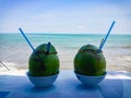 2 young coconuts served on the table, it feels fresh sitting on the beach Royalty Free Stock Photo
