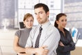 Young colleagues standing in office arms crossed Royalty Free Stock Photo