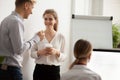 Young colleagues talking laughing at coffee break in coworking o Royalty Free Stock Photo